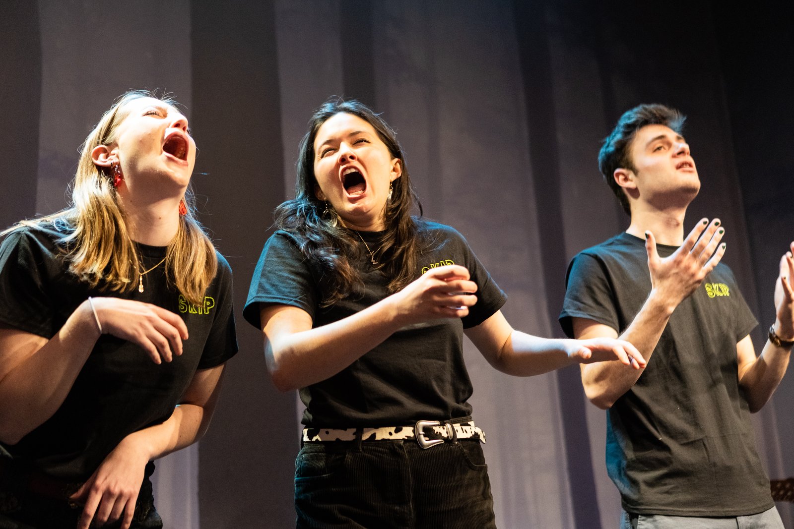 Three Skip Skip members cracking up mid-scene onstage