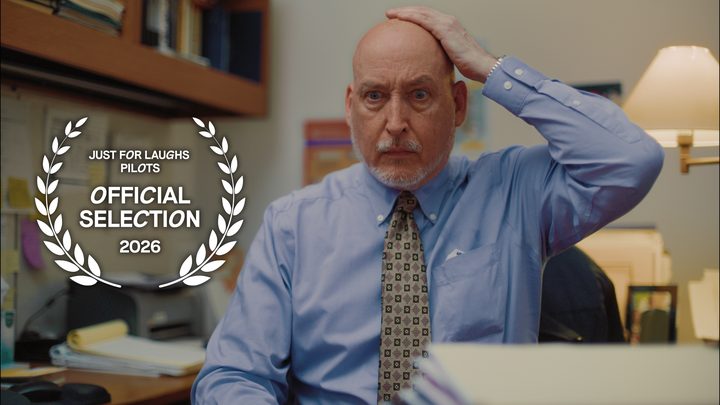Still from All Four One: their exasperated boss at his office desk, with the Just For Laughs Pilots Official Selection laurel